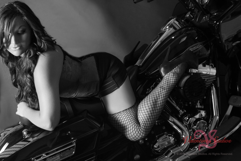 Valentine Studios boudoir photo of a beautiful woman having fun with sexy poses on her motorcycle.