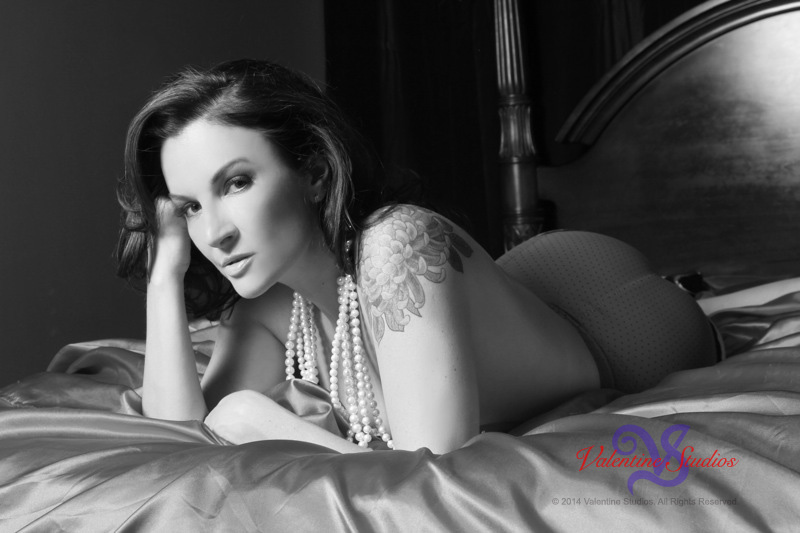 This beautiful woman looks fabulous draped in pearls during her boudoir photo shoot.