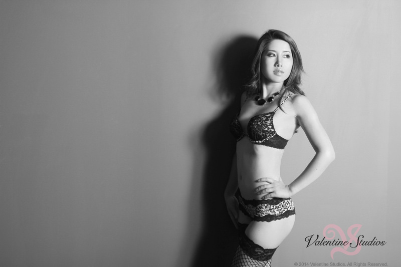This beautiful woman looks gorgeous in leopard print lingerie at her boudoir photo shoot at Valentine Studios.